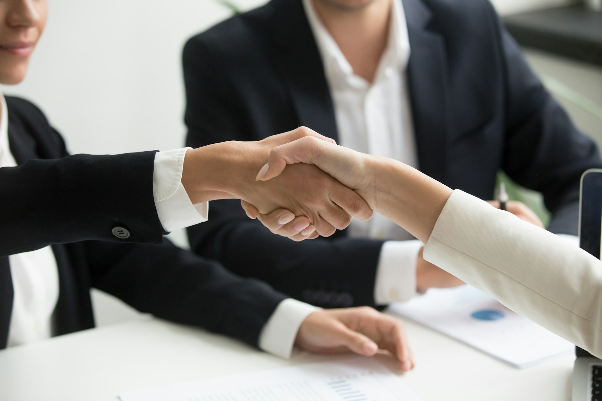 Business handshake representing a long-term technology consulting partnership